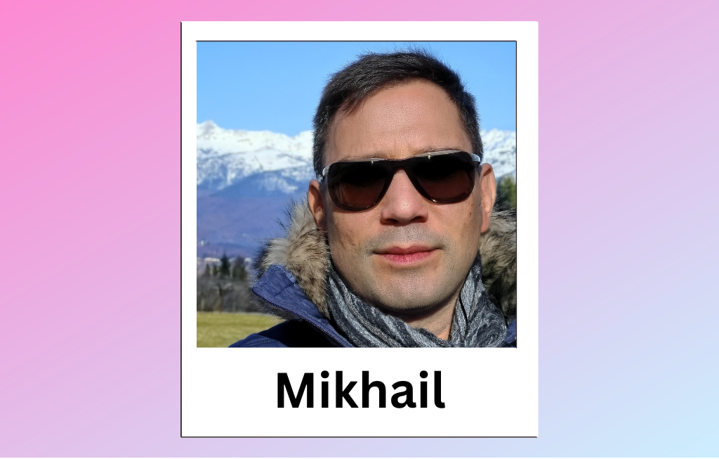 QueerPflege-LSBTIQ-Pflege Ein Mann namens Mikhail steht mit Sonnenbrille und Wintermantel im Freien, im Hintergrund sind schneebedeckte Berge zu sehen.